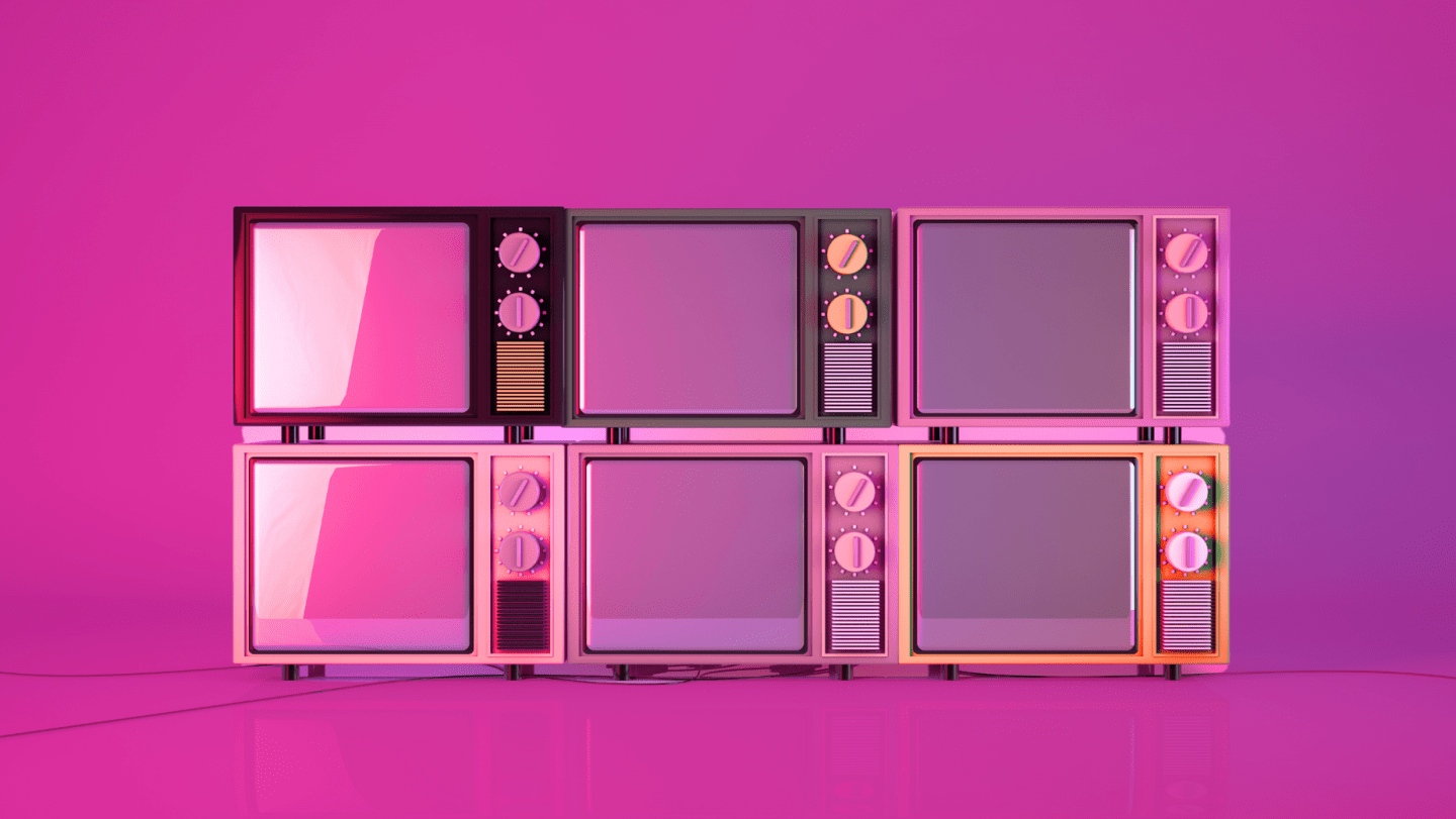 stacked televisions on a pink background